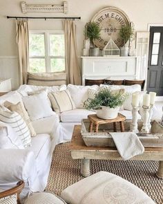 a living room filled with white furniture and pillows