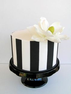 a black and white striped cake with a flower on top