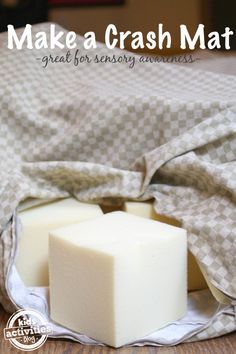 two cubes of soap sitting on top of a bed with the words make a crash mat