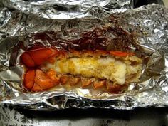 lobster wrapped in foil on top of a stove