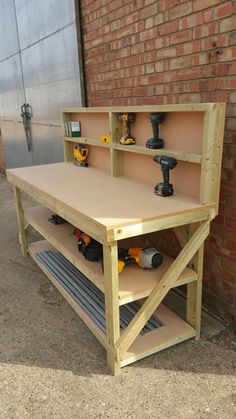 a workbench with tools on it in front of a brick wall