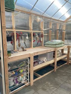 the inside of a greenhouse with shelves and tools