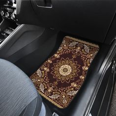 the interior of a car with a decorative floor mat