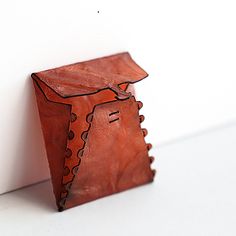 a small wooden object sitting on top of a white counter next to a wall and door