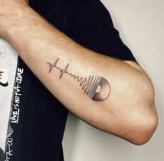 a man with a heartbeat tattoo on his arm