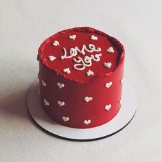 there is a red cake with white hearts on it