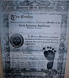 an old certificate for the birth of a baby boy is displayed on a wall in a room