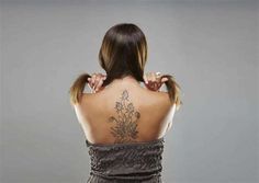 a woman with a tattoo on her back