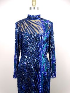 "This is a GORGEOUS Bob Mackie couture evening gown with exquisite detailing! It's in perfect condition! Bust - 36\" Waist - 30\" Hips - 40\" Dress Length - 57\" This dress comes from a pet-free and smoke-free home. If you would like more info or have any questions, please don't hesitate to ask!" Blue Embellished Cocktail Gown, Embellished Blue Cocktail Gown, Blue Embellished Gown For Cocktail, Cocktail Embellished Blue Gown, Blue Hand Embellished Formal Gown, Blue Hand Embellished Gown For Formal Occasions, Formal Blue Hand Embellished Gown, Blue Sequined Cocktail Gown, Blue Sequined Gown For Cocktail Events