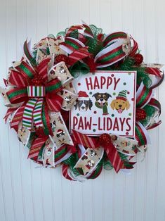 a christmas wreath that says happy paw - lid days with dogs on the front and bottom