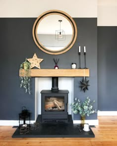 a living room with a fire place in the middle of it and a round mirror on the wall