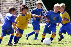 a group of young children playing soccer on a field with the words madalena's