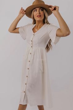 Your everyday go-to dress has arrived! The Britt Button Dress has classic wooden buttons down the front, a slight v-neckline, patch pockets, and elegant flare sleeves. This dress is available in plus sizes as well! Shop all our summer dresses on our online clothing boutique! Sister Missionary, Hooded Sweatshirt Dress, Nursing Fashion, Teacher Clothes, Dress Modest, Flare Sleeves, Newborn Lifestyle, Closet Goals, Textured Dress