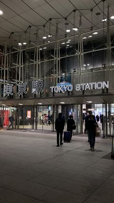 people are walking in front of the tokyo station