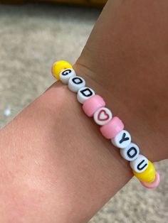 a child's bracelet with the word love spelled on it