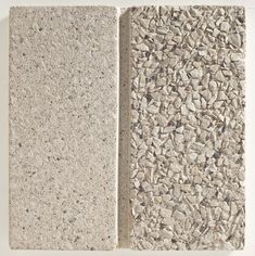 two blocks of cement with small rocks on the sides and one block of concrete between them