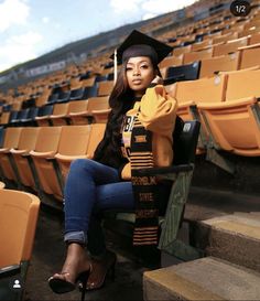 a woman sitting on the bleachers in her graduation cap and gown talking on her cell phone