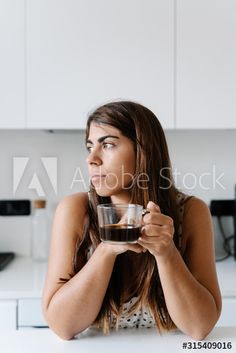 Thoughtful brown haired woman leaning elbow on table with cup of black coffee in hands and looking away at stylish kitchen , #Ad, #woman, #leaning, #elbow, #Thoughtful, #brown #Ad Brown Haired Woman, Stylish Kitchen, Black Coffee, Art Techniques, Pose Reference, Mirror Selfie, Stock Photos, Coffee, Hair