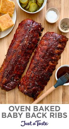 oven baked baby back ribs on a cutting board with dipping sauces and other ingredients