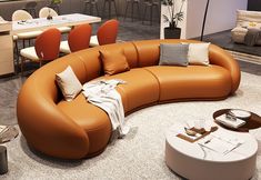 an orange leather couch sitting in the middle of a room with chairs and tables around it