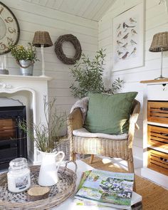 a living room filled with lots of furniture and decor on top of a table next to a fire place