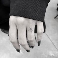 a woman's hand with a small tattoo on it