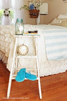 a bedroom with a white bed and blue flip flops on the floor next to it