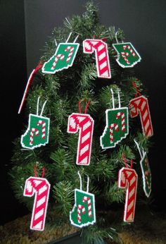 a christmas tree decorated with stockings and candy canes hanging from it's branches