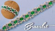 the bracelet is decorated with pearls and green stones