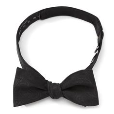 Iconic Darth Vader helmets appear in the middle of a discrete paisley pattern on this black bow tie, adding just enough detail to make an interesting statement. Self-tie bow ties are a formal wardrobe staple, and this version has been crafted from elegant 100% silk so you have something to wear to any formal event. A fully adjustable band fits most neck sizes and leaves you looking dapper wherever you go. Officially licensed by Lucasfilm LTD. Black Bow Tie With Bow Tie Back, Dapper Ties With Detachable Bow For Black-tie Events, Classic Black Suit And Tie Accessories With Detachable Bow, Pre-tied Bow For Black Tie Occasion, Dapper Black Bow With Ties, Classic Black Bow Tie With Detachable Bow, Black Detachable Bow Tie For Business, Formal Black Bow With Ties, Black Formal Bow Tie