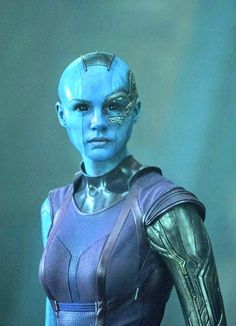 an alien woman with blue skin and leather outfit