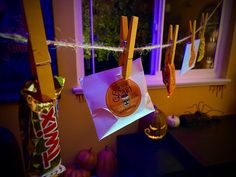 donuts hanging from clothes pins on a string in front of a window with halloween decorations