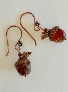 "Beautiful translucent 12 mm deep amber sunset travertine faceted Czech glass beads with reddish Picasso finish topped with artisan antique copper acorn bead caps. Earrings are wire wrapped in copper and accented with darling little antique copper TierraCast two sided oak leaf charms, antique copper daisies and tiny iridescent burnt orange Czech crystals. They hang from cute handmade copper four ball French ear hooks. Length is 1 1/2\". Matching copper acorn necklace also available in my shop. P Brown Bead Caps For Jewelry Making, Acorn Caps, Acorn Earrings, Woodland Earrings, Acorn Necklace, Oak Leaves, Oak Leaf, Czech Crystal, Leaf Charms