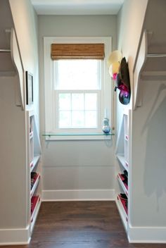 an empty walk in closet next to a window