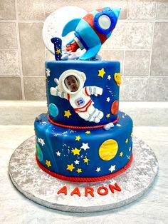 a birthday cake with an astronaut on top