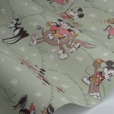 a mickey mouse wallpaper with many cartoon characters on it's green color scheme