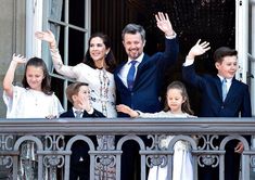 a group of people waving from a balcony