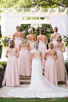 a bride and her bridal party in pink dresses