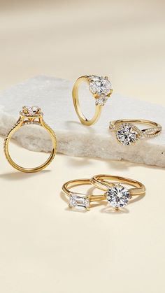 three different types of rings sitting on top of a rock