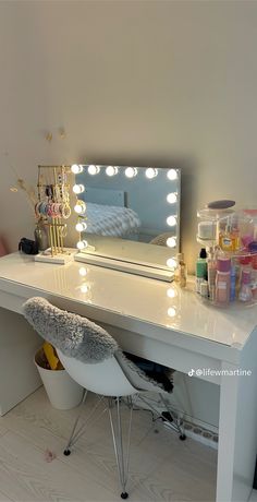 a white desk with a mirror and lights on it