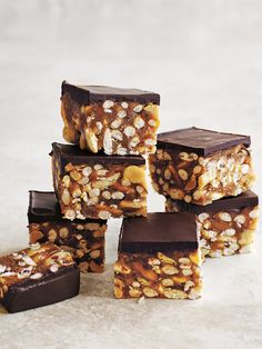 several pieces of chocolate and nuts are stacked on top of each other