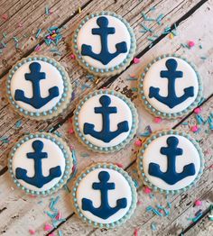 decorated cookies with blue and white icing on a wooden table