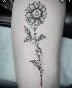 a black and white photo of a sunflower on the thigh