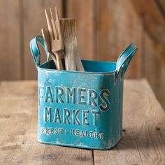 a blue metal container with utensils in it