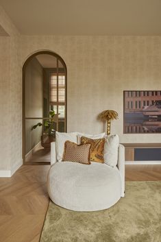 a living room filled with furniture and a painting on the wall