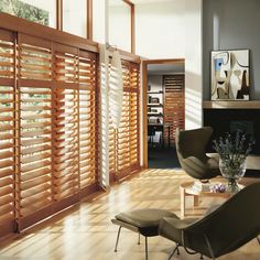 a living room filled with furniture and wooden slats