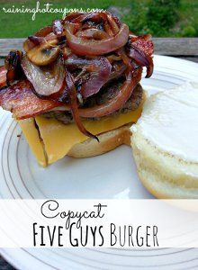 a bacon cheeseburger on a bun with onions