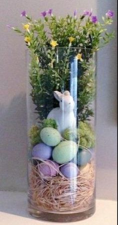 a glass vase filled with eggs and flowers