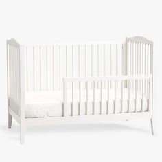 a white baby crib with no sheets on the bottom and side rails, in front of a white background