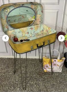 an old suitcase turned into a table with a mirror on top and two small stools underneath it